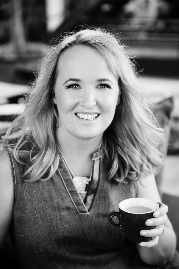 Toni smiling with a coffee