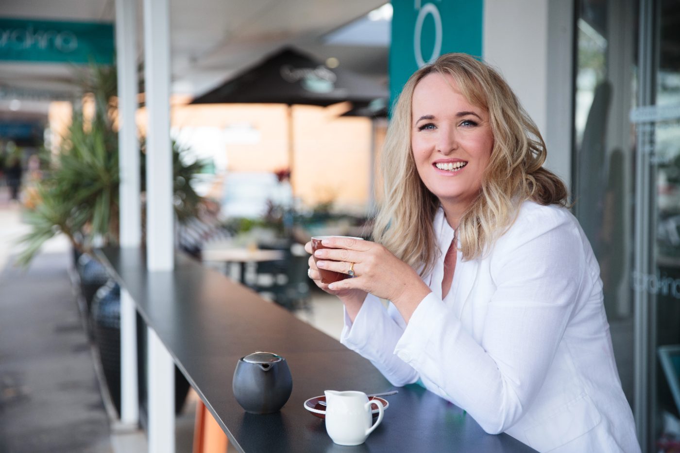 Toni, founder of My Affairs Organized, at a café table